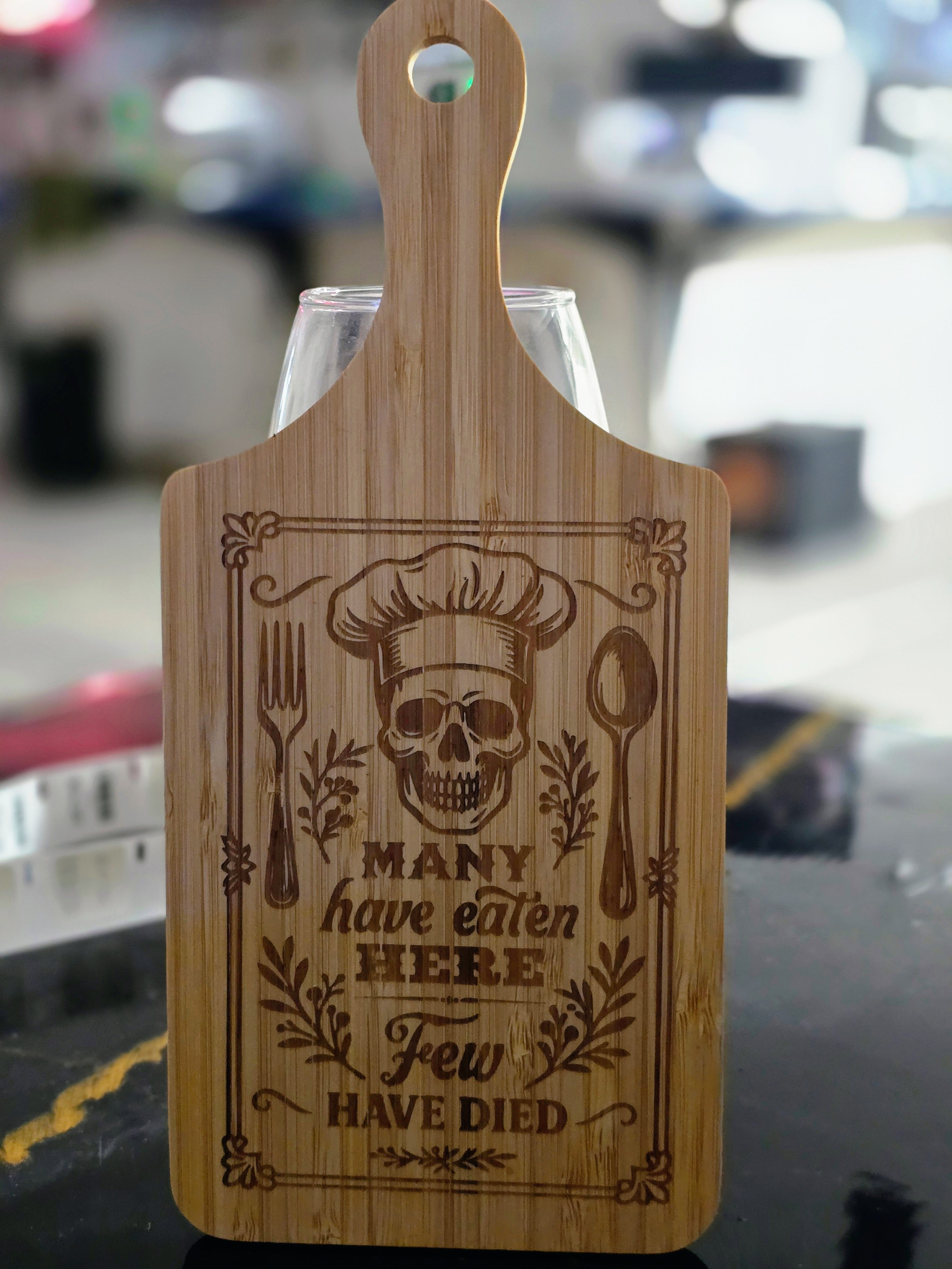 "Many have eaten here few have died" Laser-Engraved Bamboo Cutting Board – 11" Decorative & Functional Kitchen Board